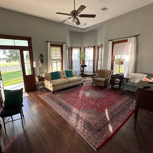 living room featuring dark hardwood / wood-style flooring and ceiling fan