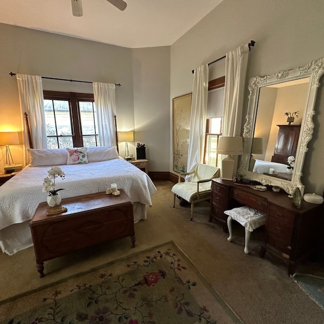 bedroom with dark colored carpet and ceiling fan