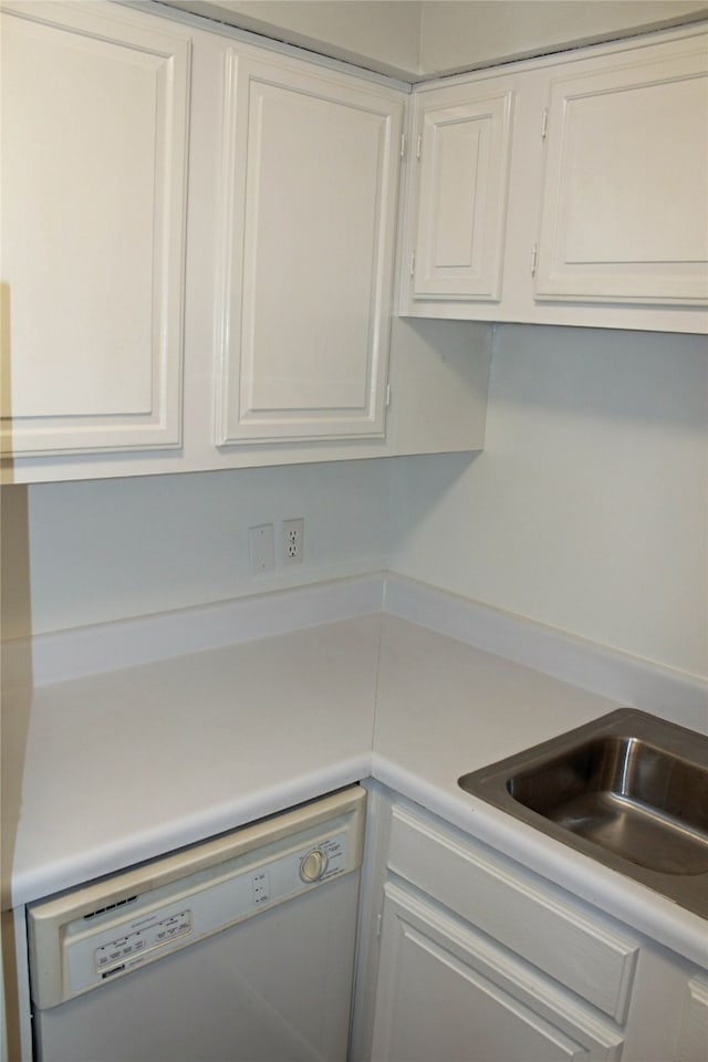 kitchen featuring white cabinets and dishwasher