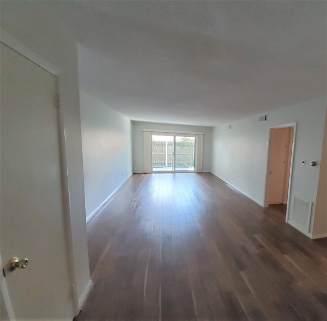 spare room with dark hardwood / wood-style floors