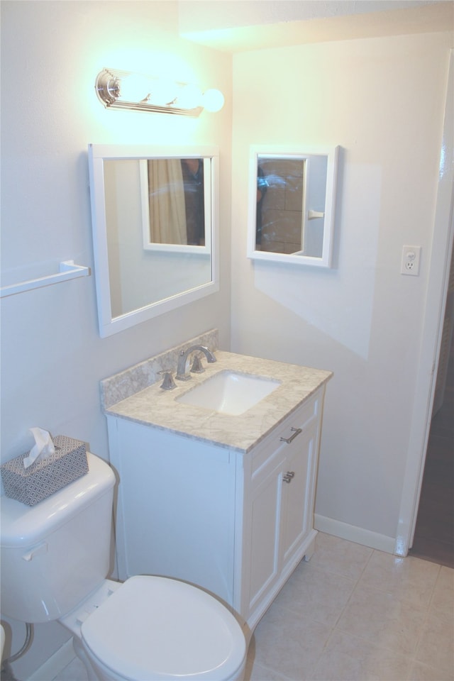 bathroom featuring tile patterned floors, vanity, and toilet