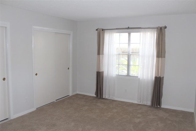 spare room featuring light colored carpet