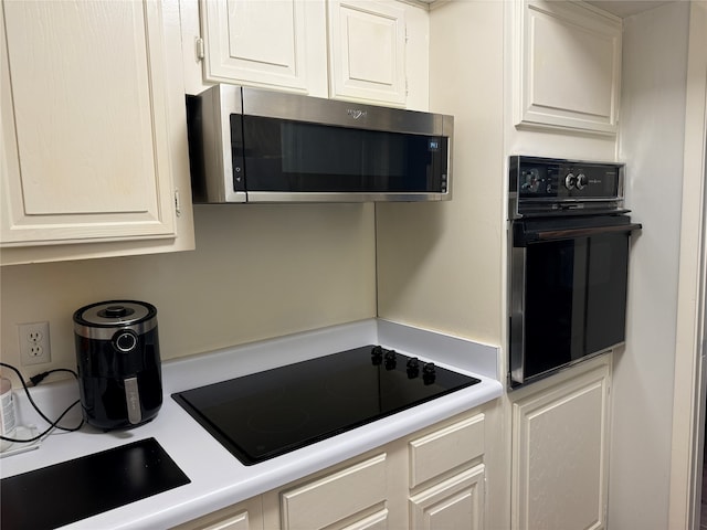 kitchen with white cabinets and black appliances