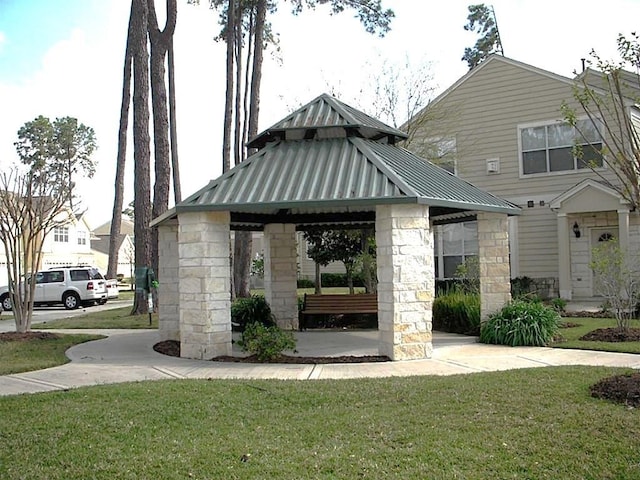 surrounding community with a gazebo and a lawn