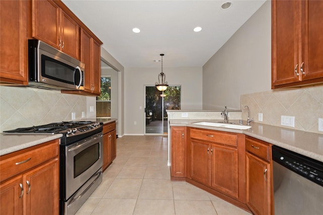 kitchen featuring sink, decorative backsplash, light tile patterned floors, decorative light fixtures, and stainless steel appliances