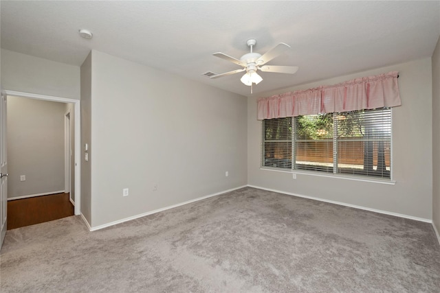 unfurnished room featuring ceiling fan and carpet floors