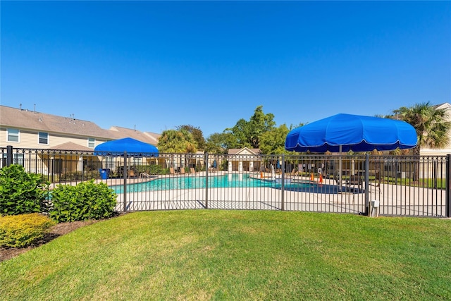 view of pool with a lawn and a patio