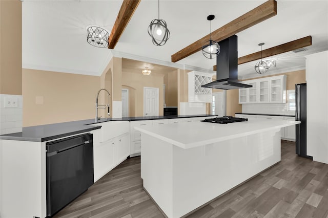 kitchen featuring beam ceiling, island exhaust hood, decorative light fixtures, decorative backsplash, and black appliances