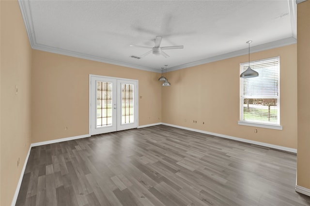 spare room featuring hardwood / wood-style floors, ceiling fan, ornamental molding, and a textured ceiling