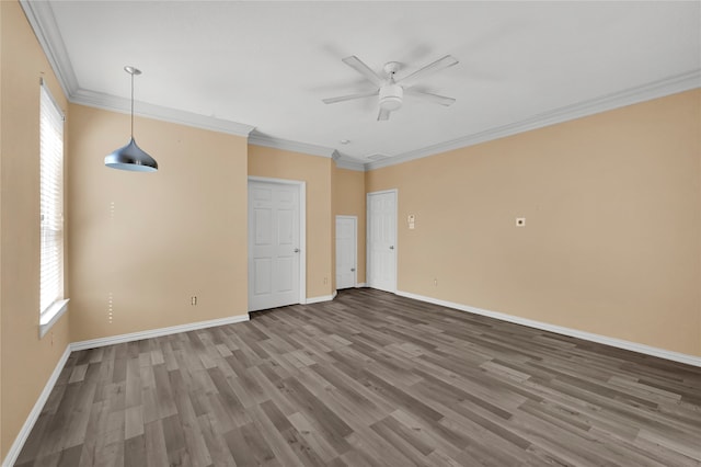 empty room featuring hardwood / wood-style floors, ceiling fan, and crown molding