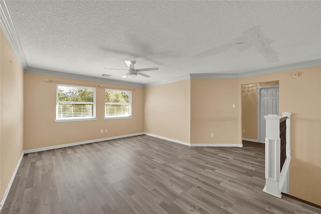 empty room featuring ceiling fan, ornamental molding, a textured ceiling, and hardwood / wood-style flooring