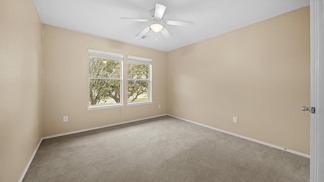 empty room featuring ceiling fan and light colored carpet