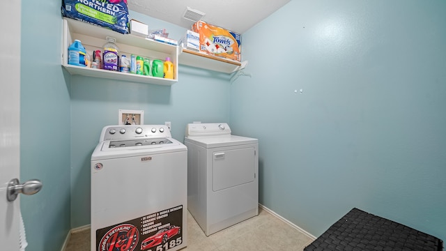 clothes washing area with separate washer and dryer