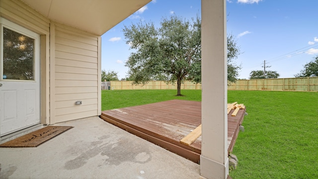 wooden terrace featuring a lawn