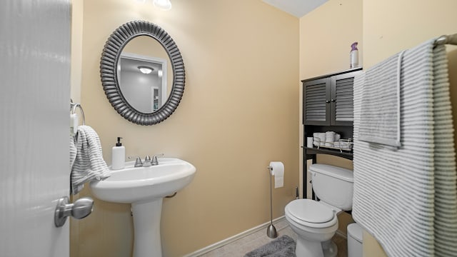 bathroom with tile patterned flooring and toilet