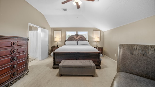 carpeted bedroom with ceiling fan and vaulted ceiling