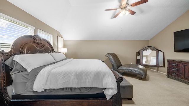 bedroom with ceiling fan, light colored carpet, and lofted ceiling