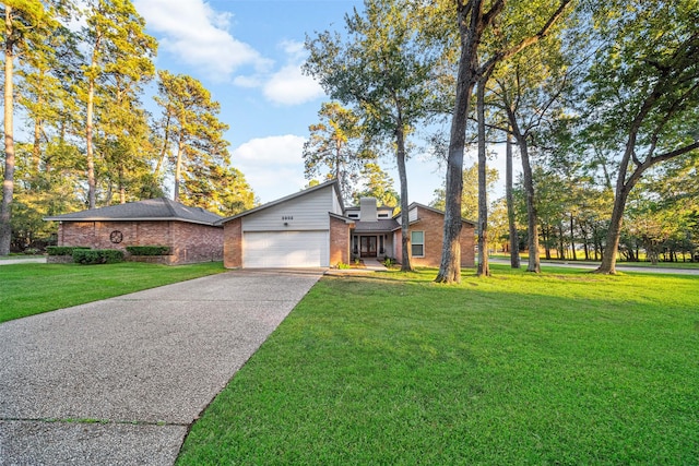 view of front of property featuring a garage and a front lawn