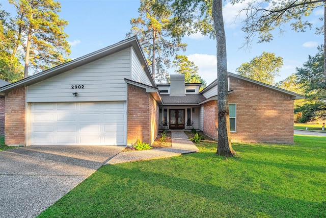 view of front of house with a front yard and a garage