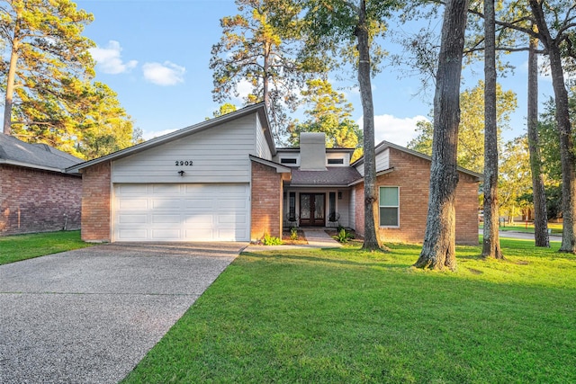 view of front of property featuring a garage and a front yard