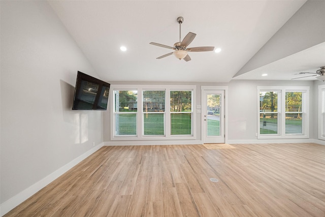 unfurnished living room featuring ceiling fan, light hardwood / wood-style floors, and vaulted ceiling