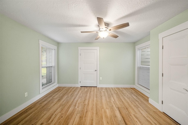 unfurnished bedroom with ceiling fan, light hardwood / wood-style flooring, and a textured ceiling