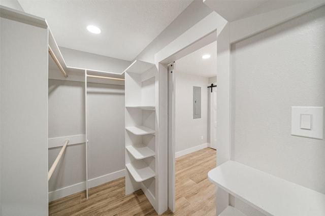 spacious closet with hardwood / wood-style floors and a barn door