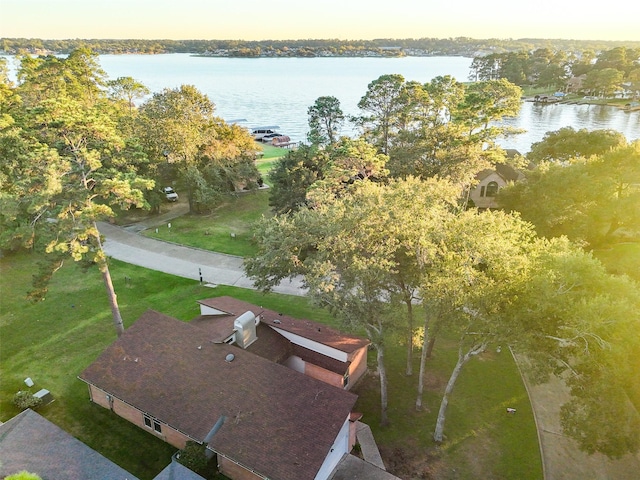 aerial view at dusk featuring a water view