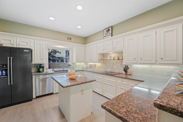 kitchen featuring a center island, white cabinets, stainless steel dishwasher, decorative backsplash, and refrigerator with ice dispenser