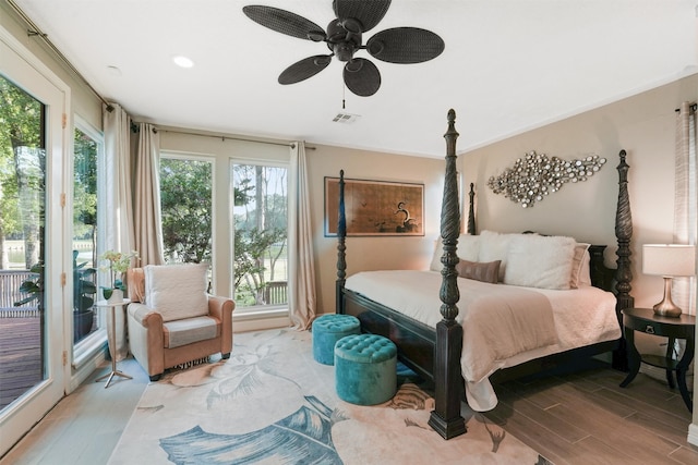 bedroom with ceiling fan, light wood-type flooring, and multiple windows