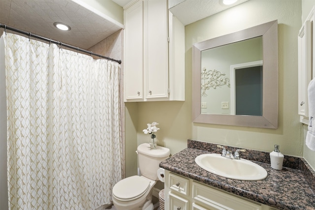 bathroom featuring vanity, curtained shower, and toilet