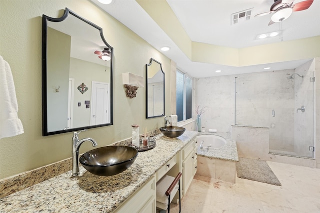 bathroom with vanity and shower with separate bathtub