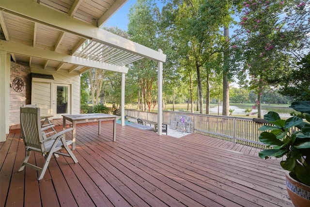 wooden deck with a pergola and a water view