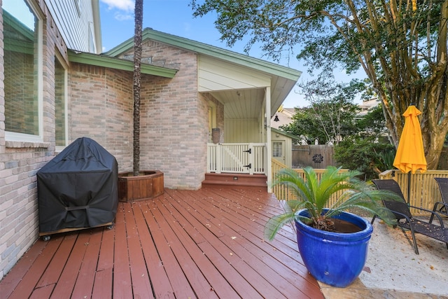 wooden terrace featuring grilling area