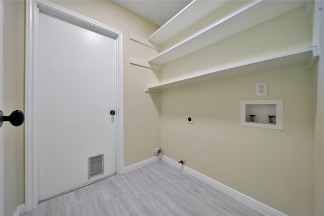 washroom featuring hookup for an electric dryer, hookup for a washing machine, and light wood-type flooring