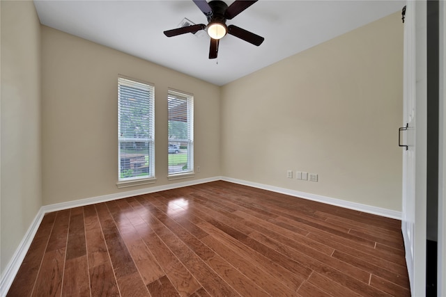 spare room with ceiling fan and dark hardwood / wood-style flooring