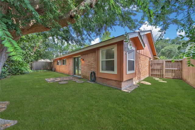 rear view of property with a yard