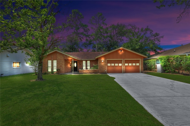 ranch-style house with a garage and a yard