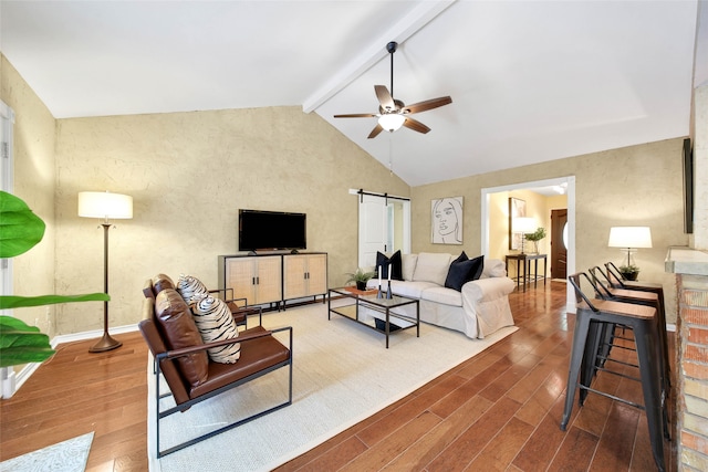 living room with vaulted ceiling with beams, dark hardwood / wood-style floors, a barn door, and ceiling fan