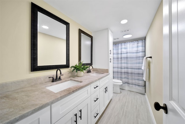 full bathroom featuring vanity, toilet, and shower / bathtub combination with curtain