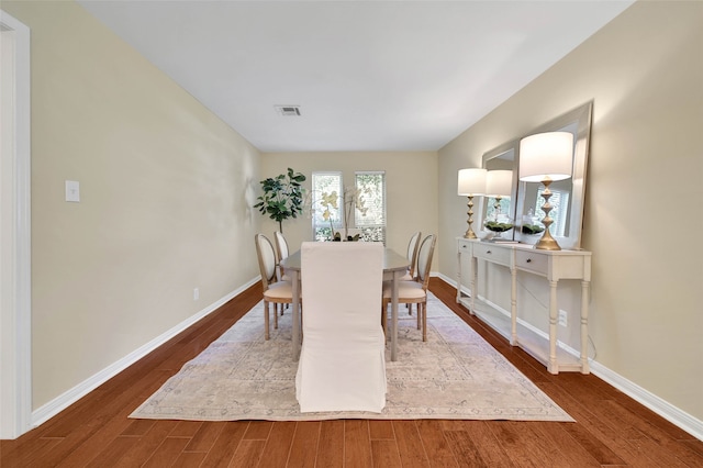 dining room with dark hardwood / wood-style flooring