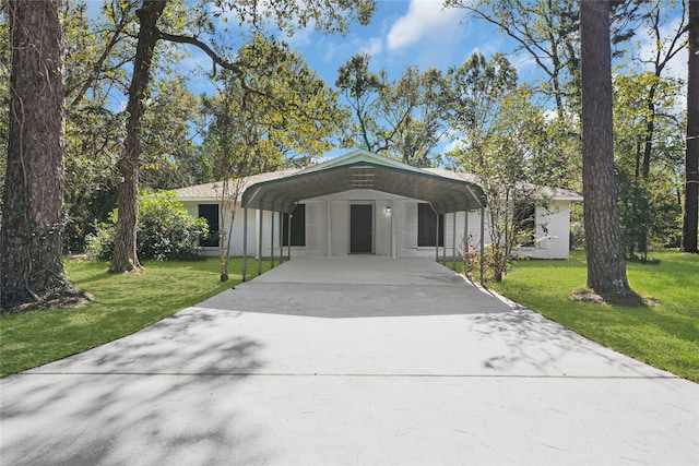 view of front facade with a front lawn and a carport