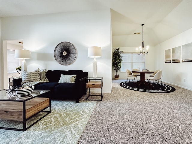 carpeted living room featuring lofted ceiling and a chandelier