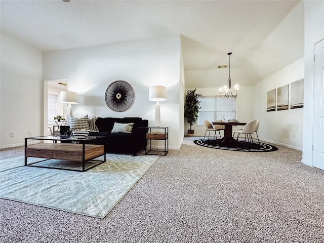 living room with carpet flooring, lofted ceiling, and an inviting chandelier