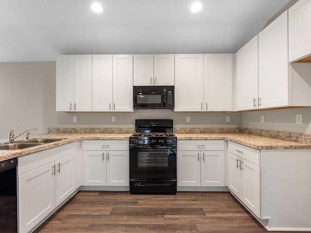 kitchen featuring dark wood-type flooring, white cabinetry, sink, and black appliances