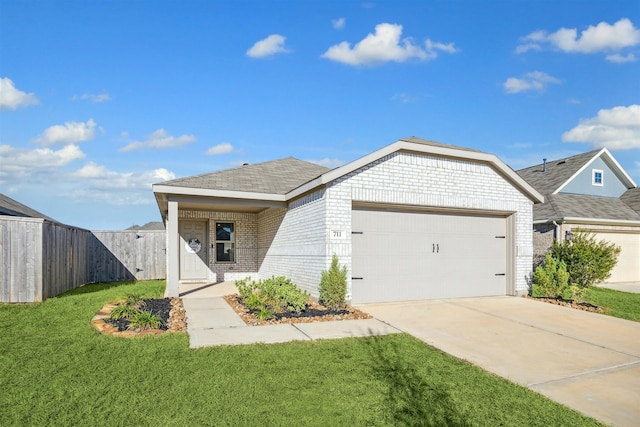 view of front of property featuring a garage and a front lawn