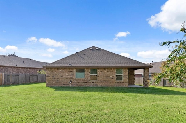 rear view of property featuring a lawn