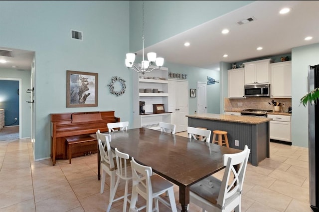 dining area featuring light tile patterned floors and a notable chandelier