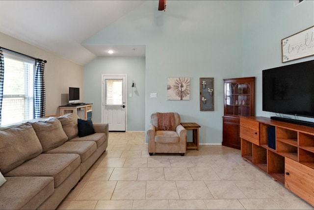 living room featuring a wealth of natural light, light tile patterned floors, and ceiling fan