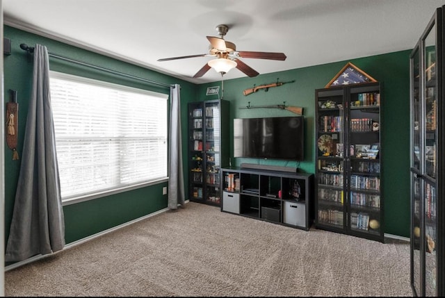 carpeted living room with ceiling fan